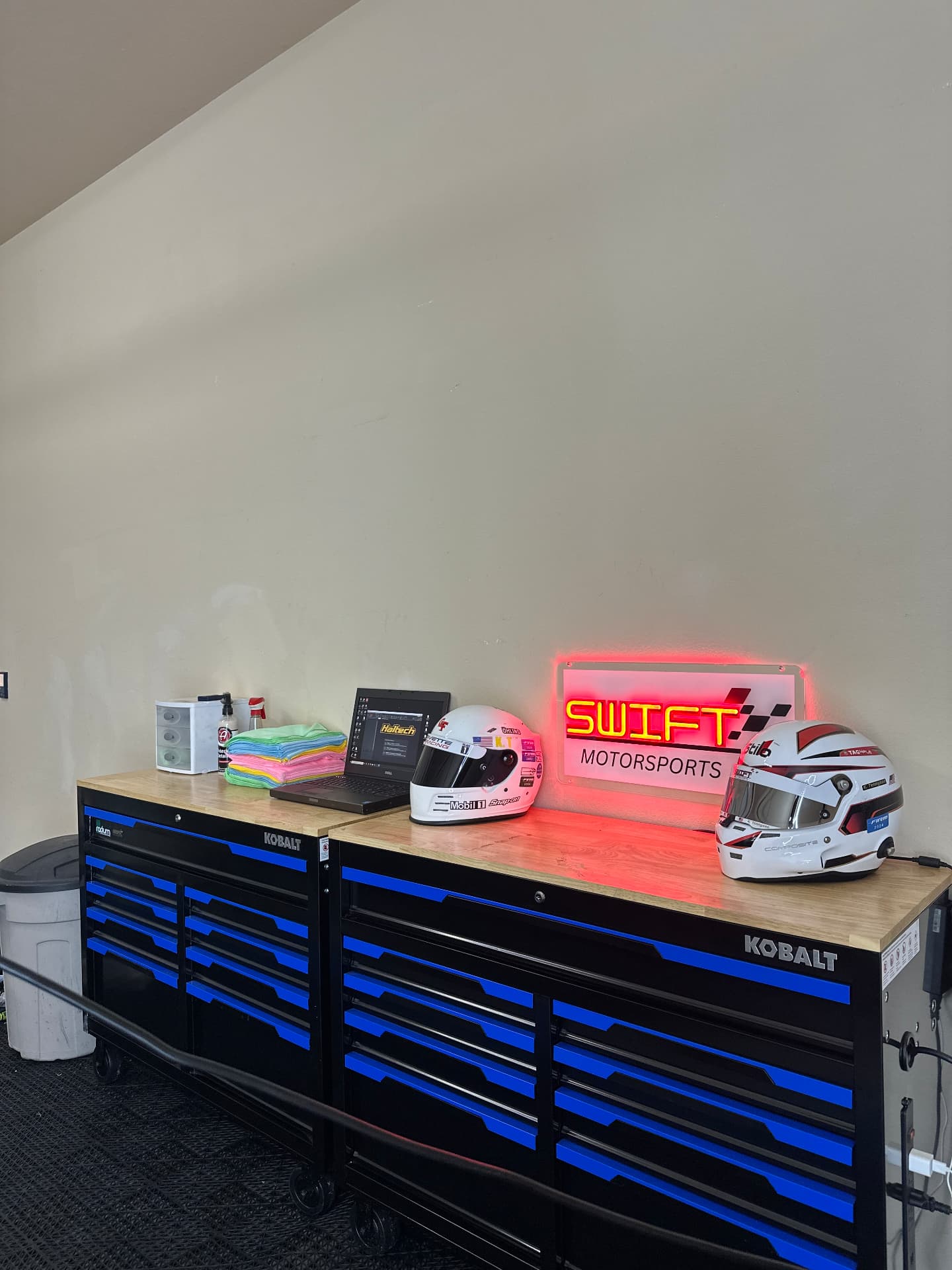 Swift Motorsports workshop with Haltech laptop and helmets