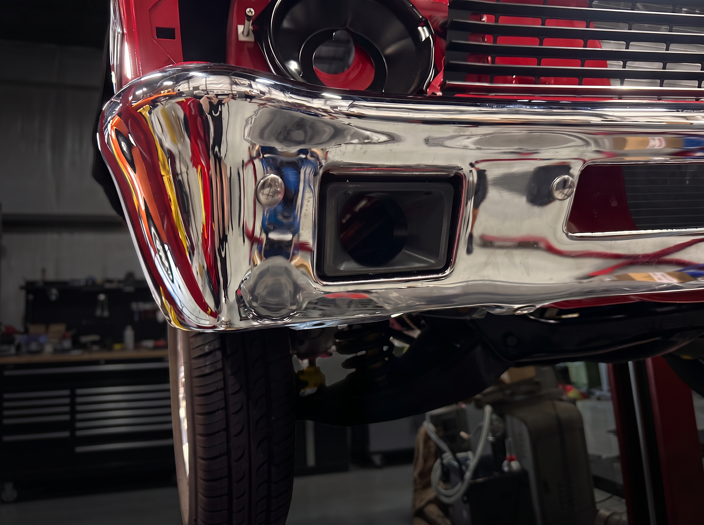 Front view of the prototype brake cooling duct test-fitted in the Nova chrome bumper, digitally recolored black